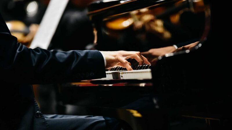 Pianist Playing A Piece On A Grand Piano At A Concert